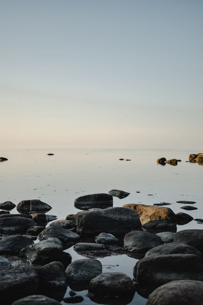 Serene seascape with rocky shore during dusk in Estonia, perfect for nature lovers.